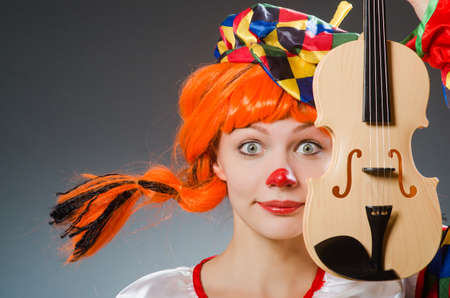 Clown in funny concept on dark backgroundの写真素材