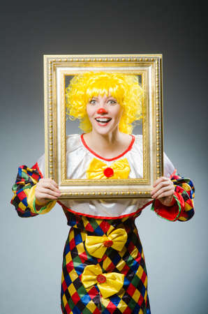 Clown in funny concept on dark backgroundの写真素材