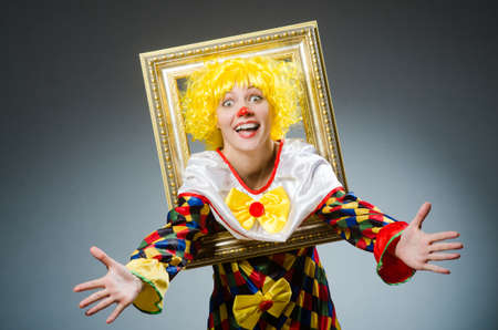 Clown in funny concept on dark backgroundの写真素材