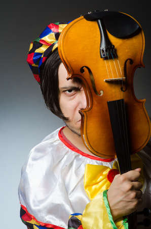 Funny violin clown player in musical conceptの写真素材