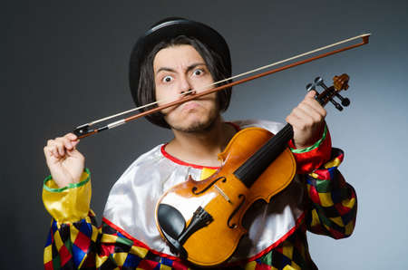 Funny violin clown player in musical conceptの写真素材