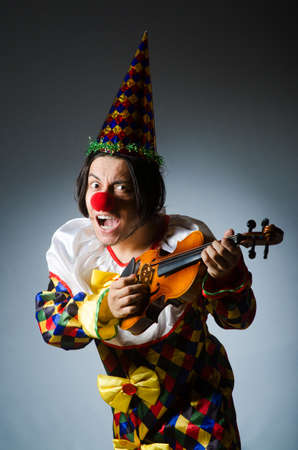 Funny violin clown player in musical conceptの写真素材