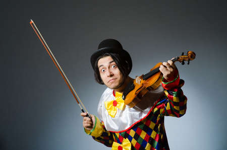 Funny violin clown player in musical conceptの写真素材