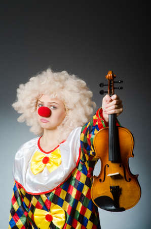 Clown in funny concept on dark backgroundの写真素材