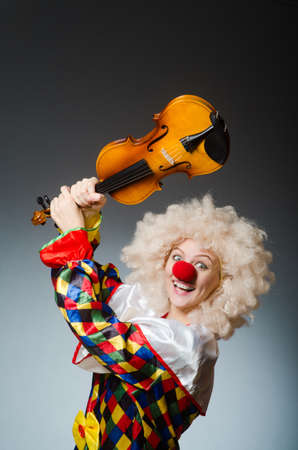 Clown in funny concept on dark backgroundの写真素材