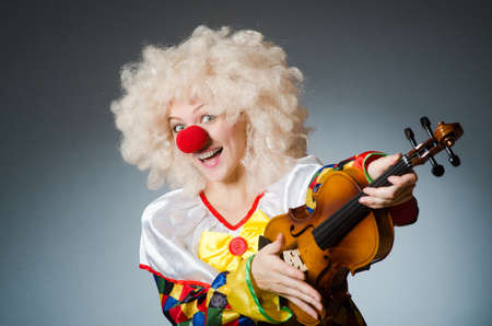 Clown in funny concept on dark backgroundの写真素材