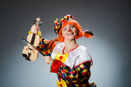 Clown in funny concept on dark backgroundの写真素材