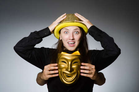 Woman with mask in funny conceptの写真素材
