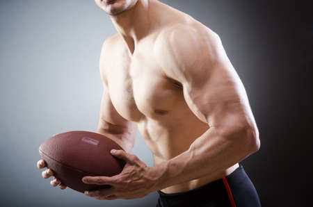 Muscular man with american footballの写真素材