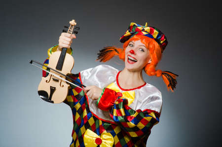 Clown in funny concept on dark backgroundの写真素材