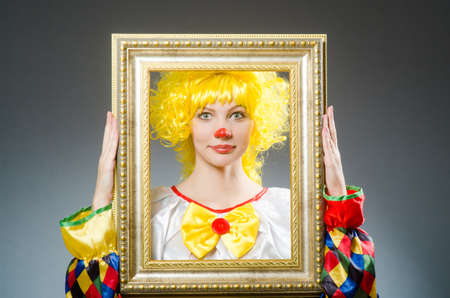 Clown in funny concept on dark backgroundの写真素材