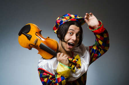 Funny violin clown player in musical conceptの写真素材