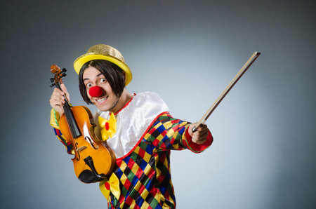 Funny violin clown player in musical conceptの写真素材