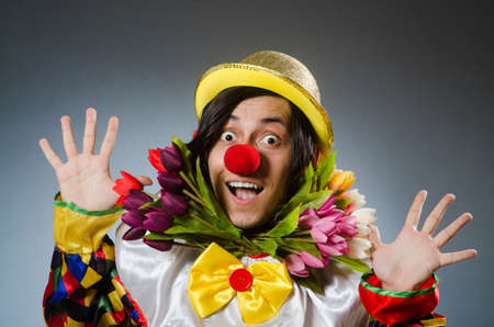 Clown with tulip flowers in funny conceptの写真素材