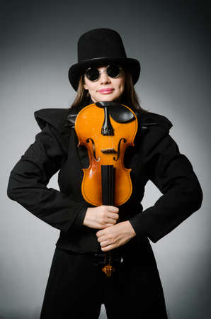 Woman playing classical violin in music conceptの写真素材