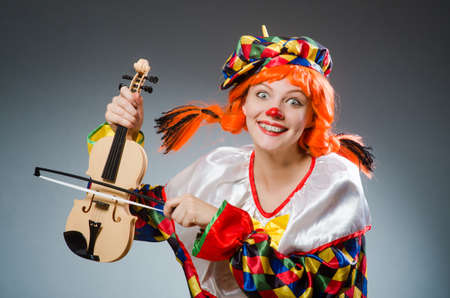 Clown in funny concept on dark backgroundの写真素材