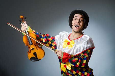 Funny violin clown player in musical conceptの写真素材