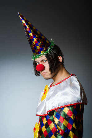 Funny clown against dark backgroundの写真素材