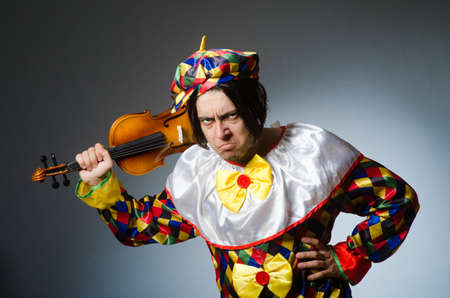 Funny violin clown player in musical concept