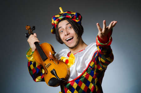 Funny violin clown player in musical conceptの写真素材
