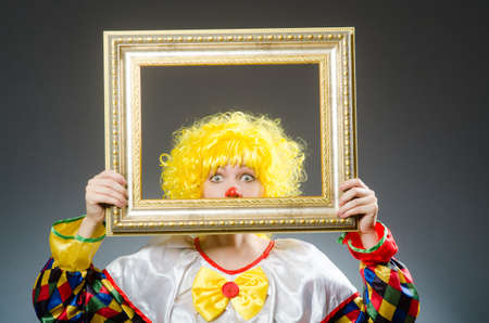 Clown in funny concept on dark backgroundの写真素材