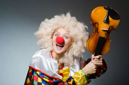 Clown in funny concept on dark backgroundの写真素材