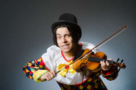 Funny violin clown player in musical conceptの写真素材