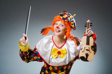 Clown in funny concept on dark backgroundの写真素材