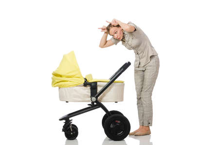 Woman with baby and pram isolated on whiteの写真素材