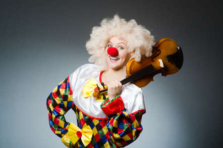 Clown in funny concept on dark backgroundの写真素材
