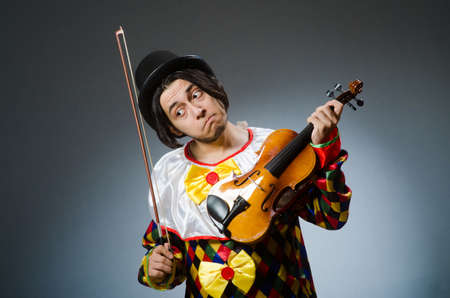 Funny violin clown player in musical conceptの写真素材