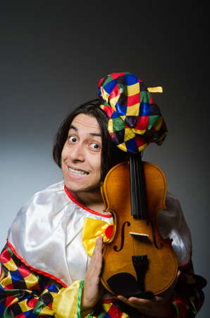 Funny violin clown player in musical conceptの写真素材