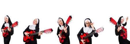 Nun with guitar isolated on whiteの写真素材