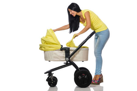 Woman with baby and pram isolated on whiteの写真素材