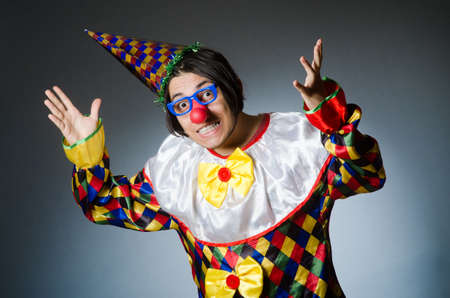 Funny clown against dark backgroundの写真素材