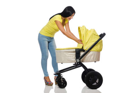Woman with baby and pram isolated on whiteの写真素材