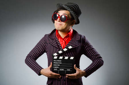 Funny man with movie boardの写真素材