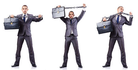 Businessman with shackles on whiteの写真素材