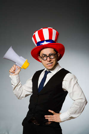 Man with loudspeaker wearing american hatの写真素材
