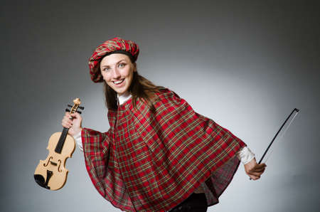 Woman in scottish clothing in musical conceptの写真素材