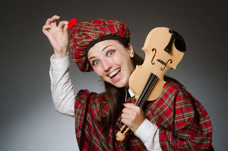 Woman in scottish clothing in musical conceptの写真素材