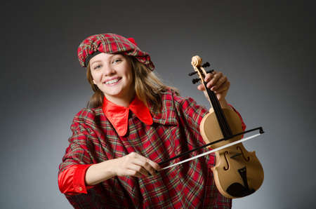 Woman in scottish clothing in musical conceptの写真素材