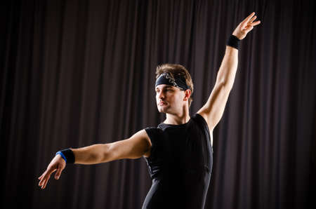 Young man training for ballet dancesの写真素材
