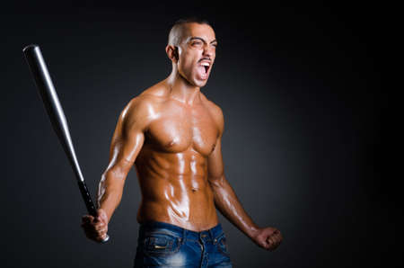 Ripped man with baseball batの写真素材
