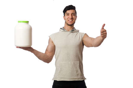 Muscular man with protein jars on white
