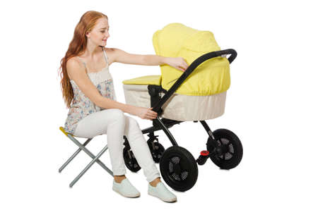 Woman with baby and pram isolated on whiteの写真素材