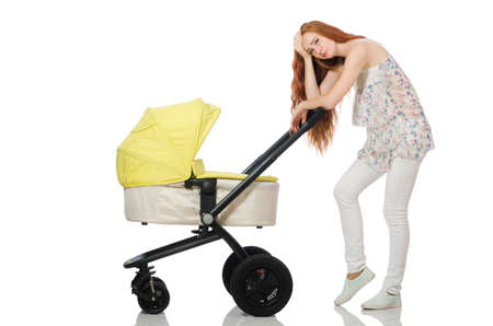 Woman with baby and pram isolated on whiteの写真素材