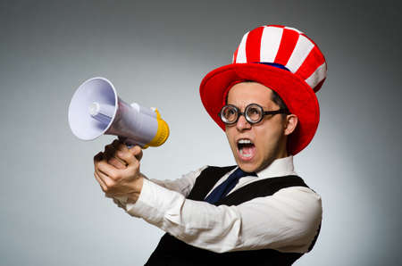 Man with loudspeaker wearing american hatの写真素材
