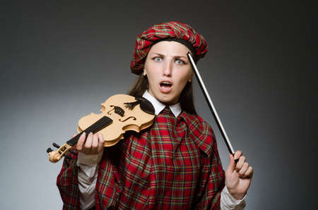 Woman in scottish clothing in musical conceptの写真素材