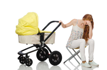 Woman with baby and pram isolated on whiteの写真素材